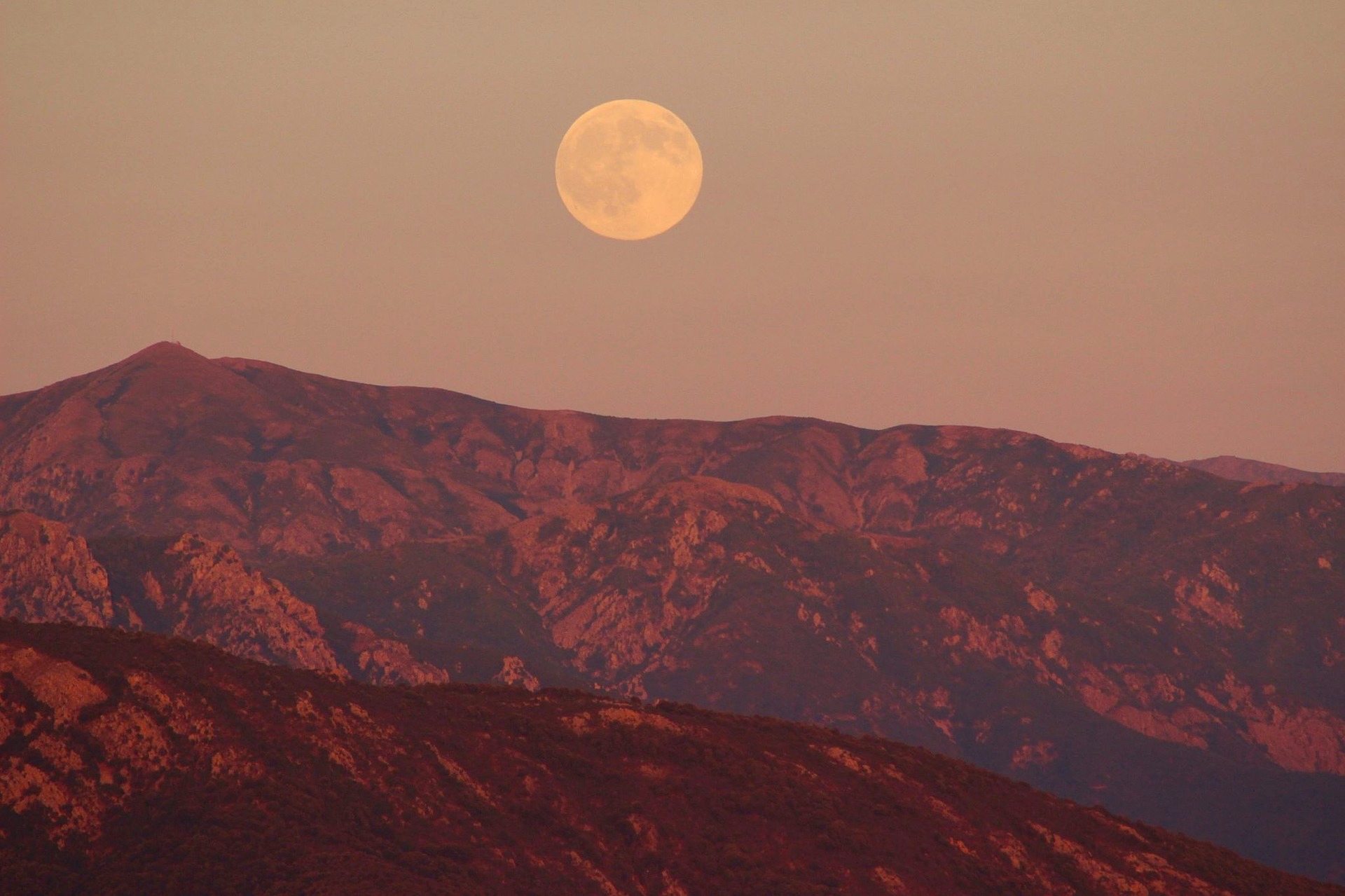 Full Pink Moon over mountains
